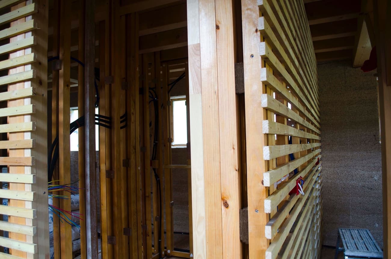 Architectural project - exposed timber, construction elements, wooden framework, linear pattern, unfinished space, architectural structure, framework, natural materials, wood, timber, raw materials, timber frame, natural light, warm tones, sustainable construction, timber structure, construction site, under construction, modern construction, daylight, structural design, light wood, modern aesthetic, honey wood, minimalist architecture, contemporary design, minimalist design, wood construction, building process, eco building, timber elements, structural wood, exposed wood, construction detail, timber architecture, timber cladding, wood cladding, beige tones, eco architecture, wooden slats, vertical slats, architectural rhythm