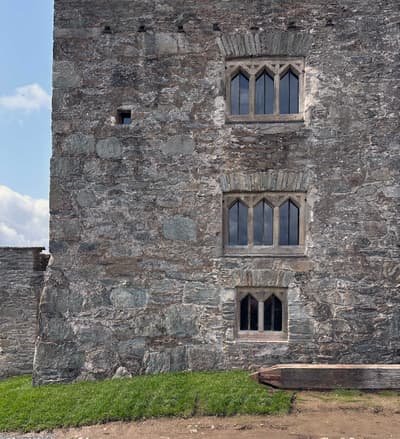 Architectural project - stone facade, exposed stone, heritage preservation, textured stone, rustic stone, stone architecture, robust structure, historic building, arched windows, historical vibe, traditional construction, masonry, old building, castle-like, architectural detail, grey, neutral tones, outdoor setting, beige, exterior wall, rustic charm, landscape view, stone, small window, rough texture, stonework, earthy tones, classic architecture, grey stone, timeless design