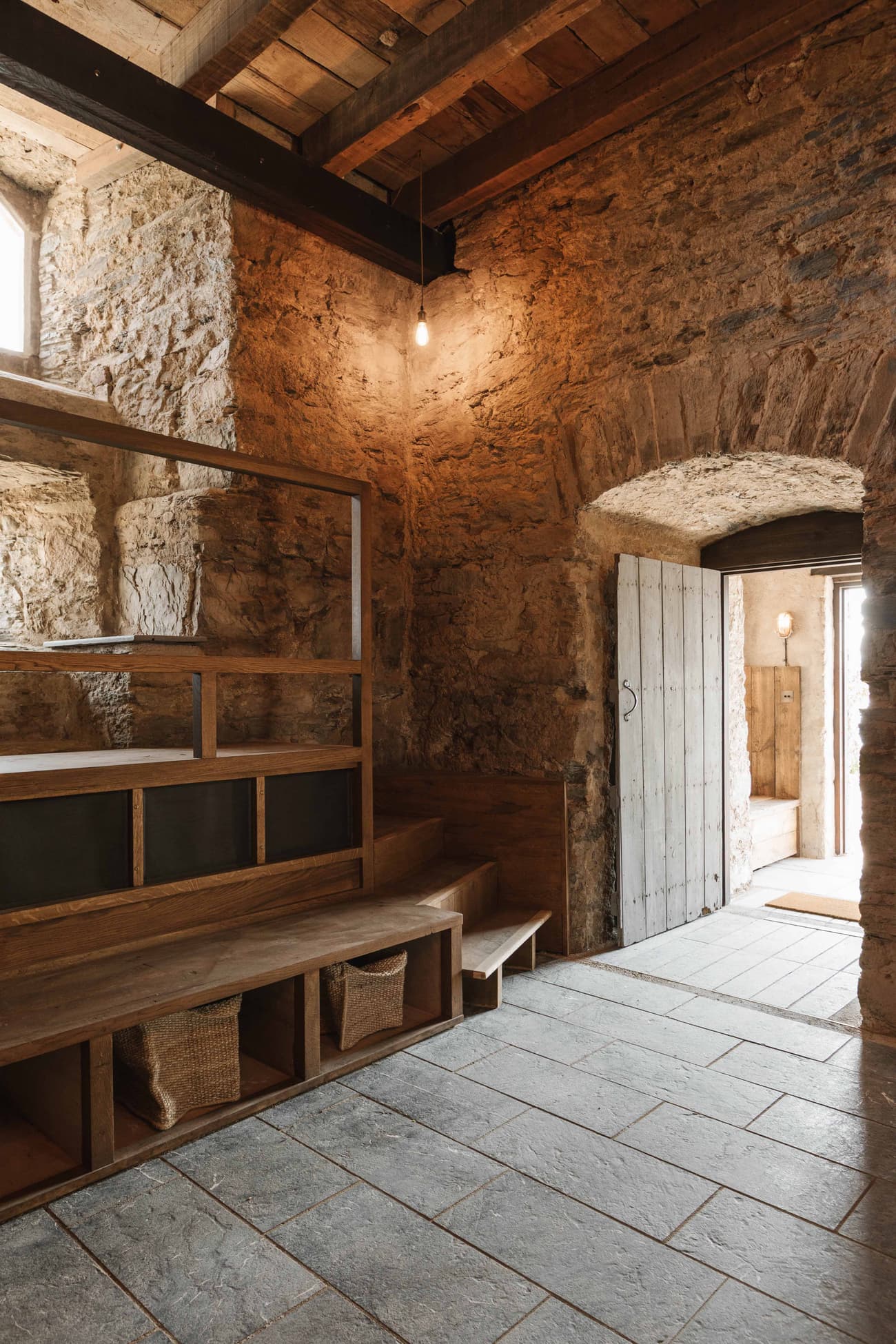 Architectural project - natural stone, ambient light, stone walls, countryside charm, rustic interior, vintage style, reclaimed wood, rustic hallway, historical building, heritage restoration, cozy interior, natural materials, soft lighting, wood, timber, inviting atmosphere, sustainable design, warm tones, grey, exposed beams, beige, brown, wooden beams, farmhouse style, timber beams, adaptive reuse, eco-friendly materials, cozy vibe, stone, warm ambiance, rough texture, earthy tones, rustic design, traditional architecture, natural texture, stone arch, craftmanship, heritage building, stone floor, warm lighting, renovation, country home, artisanal touch, vaulted ceiling