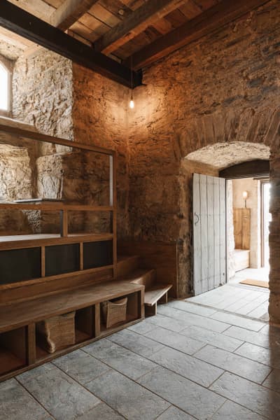 Architectural project - natural stone, ambient light, stone walls, countryside charm, rustic interior, vintage style, reclaimed wood, rustic hallway, historical building, heritage restoration, cozy interior, natural materials, soft lighting, wood, timber, inviting atmosphere, sustainable design, warm tones, grey, exposed beams, beige, brown, wooden beams, farmhouse style, timber beams, adaptive reuse, eco-friendly materials, cozy vibe, stone, warm ambiance, rough texture, earthy tones, rustic design, traditional architecture, natural texture, stone arch, craftmanship, heritage building, stone floor, warm lighting, renovation, country home, artisanal touch, vaulted ceiling