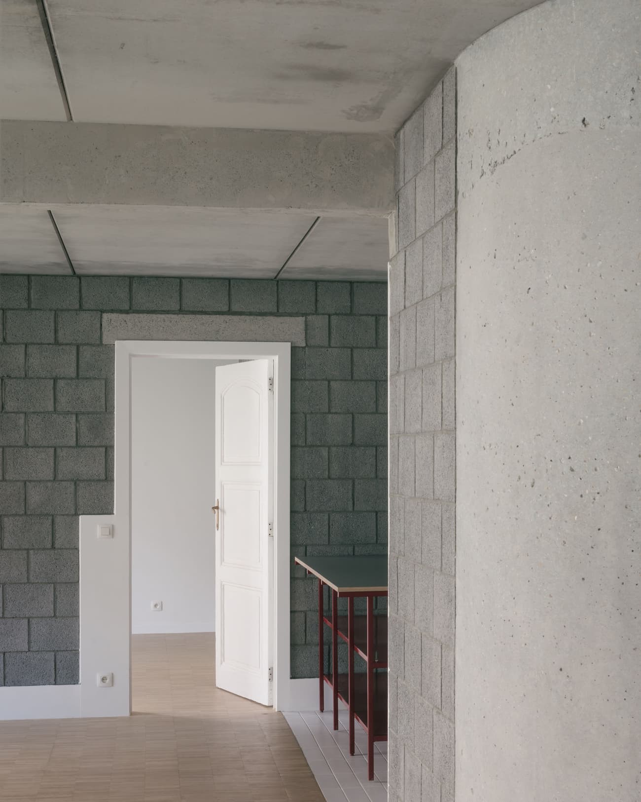 Architectural project - exposed concrete, urban feel, unfinished look, modern renovation, open doorway, transitional space, industrial, white door, concrete interior, cement block wall, gray wall, modular block, interior threshold, minimal vibe, concrete aesthetic, brutalist design, structural simplicity, clean transition, architectural concept, unique wall texture, light ambiance, cement, raw, minimalist, architectural detail, grey tones, raw materials, grey, neutral tones, functional space, concrete, geometric pattern, modern aesthetic, industrial style, minimalist design, contemporary home, clean lines, white, textured wall, open plan, residential space, neutral, modern interior