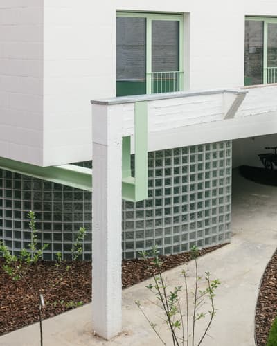 Architectural project - urban greenery, light-filled space, urban building, green accents, urban dwelling, green windows, natural elements, polished look, crisp design, transparent blocks, glass bricks, curved walls, sleek building, sophisticated design, eco-friendly elements, sustainable design, glass, contemporary style, green, neutral tones, concrete, exterior design, functional design, daylight optimization, modern design, urban oasis, minimalist architecture, streamlined architecture, urban design, clean aesthetic, geometric design, modern facade, clean lines, white facade, white, residential architecture, textured facade, seamless integration, innovative facade, modern exterior, architectural contrast, glass wall, residential facade, architectural feature, modern materials