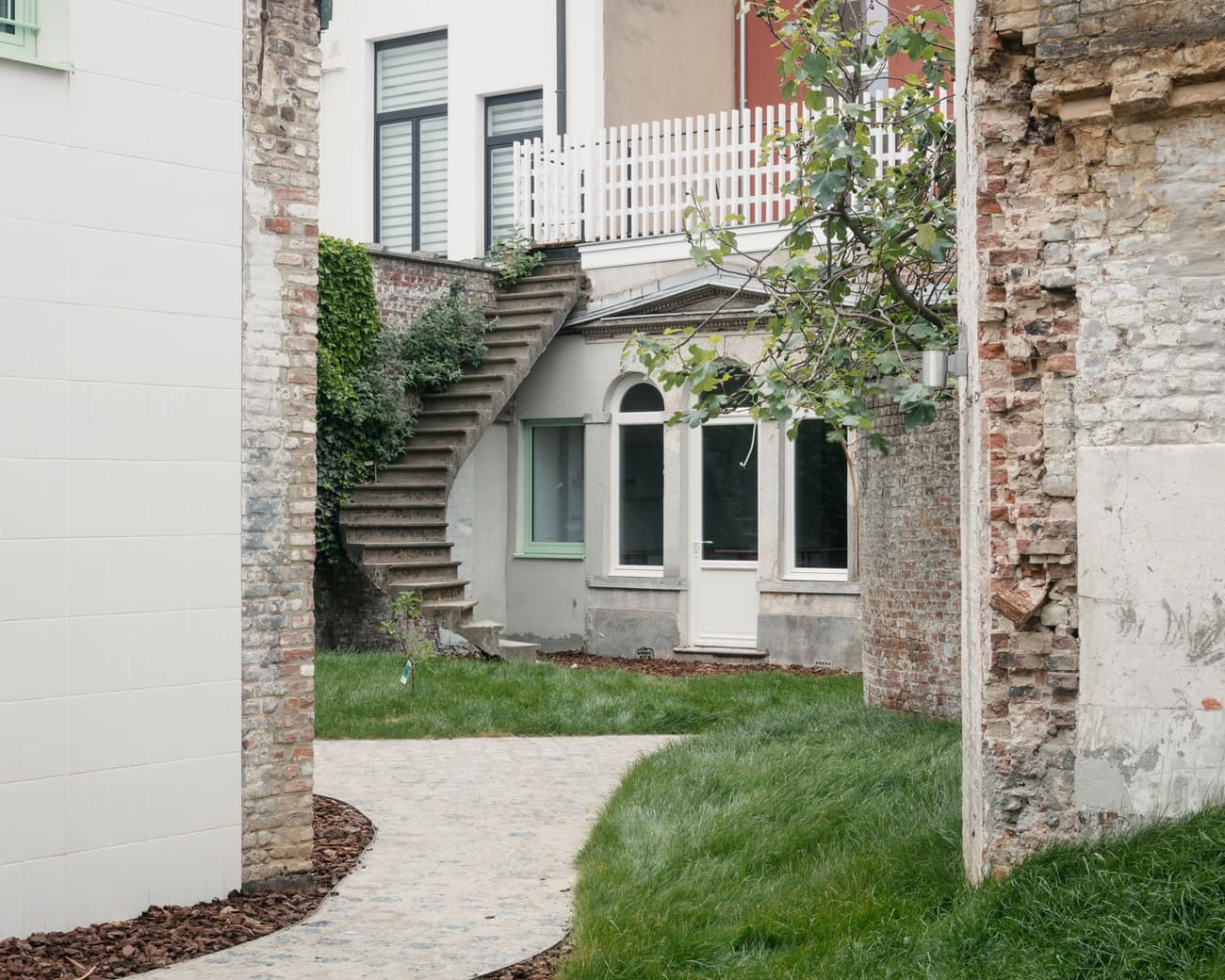 Architectural project - concrete stairs, city escape, brick wall, juxtaposition, brickwork, exposed brick, outdoor stairs, urban courtyard, light green, stone walkway, historic vibe, city retreat, residential courtyard, layered architecture, urban texture, vintage feel, small garden, minimalist landscape, restoration, private courtyard, hidden gem, architectural layers, outdoor tranquility, eclectic style, outdoor living, warm tones, outdoor area, grey, green, beige, concrete, compact space, urban oasis, rustic charm, intimate setting, earth tones, rustic finish, stone, brick, brick facade, greenery, cozy exterior, contemporary facade, garden path, urban nature, urban garden, renovation, architectural contrast, exterior space, staircase, vertical garden