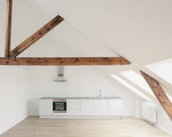 Architectural project - loft kitchen, contemporary kitchen, airy interior, roof window, white cabinetry, attic kitchen, white kitchen, rustic beams, brick walls, simple cabinetry, built-in oven, honey wood floor, apartment kitchen, spacious vibe, natural light, warm tones, neutral tones, exposed beams, functional space, brown, light wood, eco friendly, wood beams, timber beams, Scandinavian style, neutral palette, modern rustic, sustainable home, white walls, white, Nordic design, cozy vibe, energy efficient, home kitchen, open plan, warm atmosphere, residential space, bright interior, minimalist kitchen, sleek design, compact kitchen, calm atmosphere, plaster walls, open space, clean design, renovation, sloped ceiling, skylight, remodel
