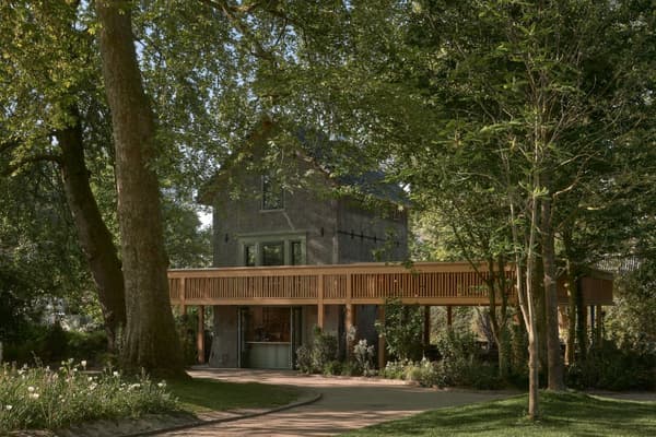 Architectural project - secluded spot, garden house, integration with nature, countryside style, shaded area, rural aesthetics, wraparound deck, scenic retreat, wood deck, wood, timber, outdoor living, passive design, sustainable design, warm tones, green, timber structure, beige, brown, eco friendly, natural setting, rustic charm, wood construction, tranquil setting, natural landscape, biophilic design, stone, earthy tones, tree canopy, rustic facade, treehouse, peaceful escape, nature retreat, forest view, timber deck, forest hideaway, woodland cabin, nature immersion, cozy exterior, eco retreat, garden path, lush greenery, green surroundings