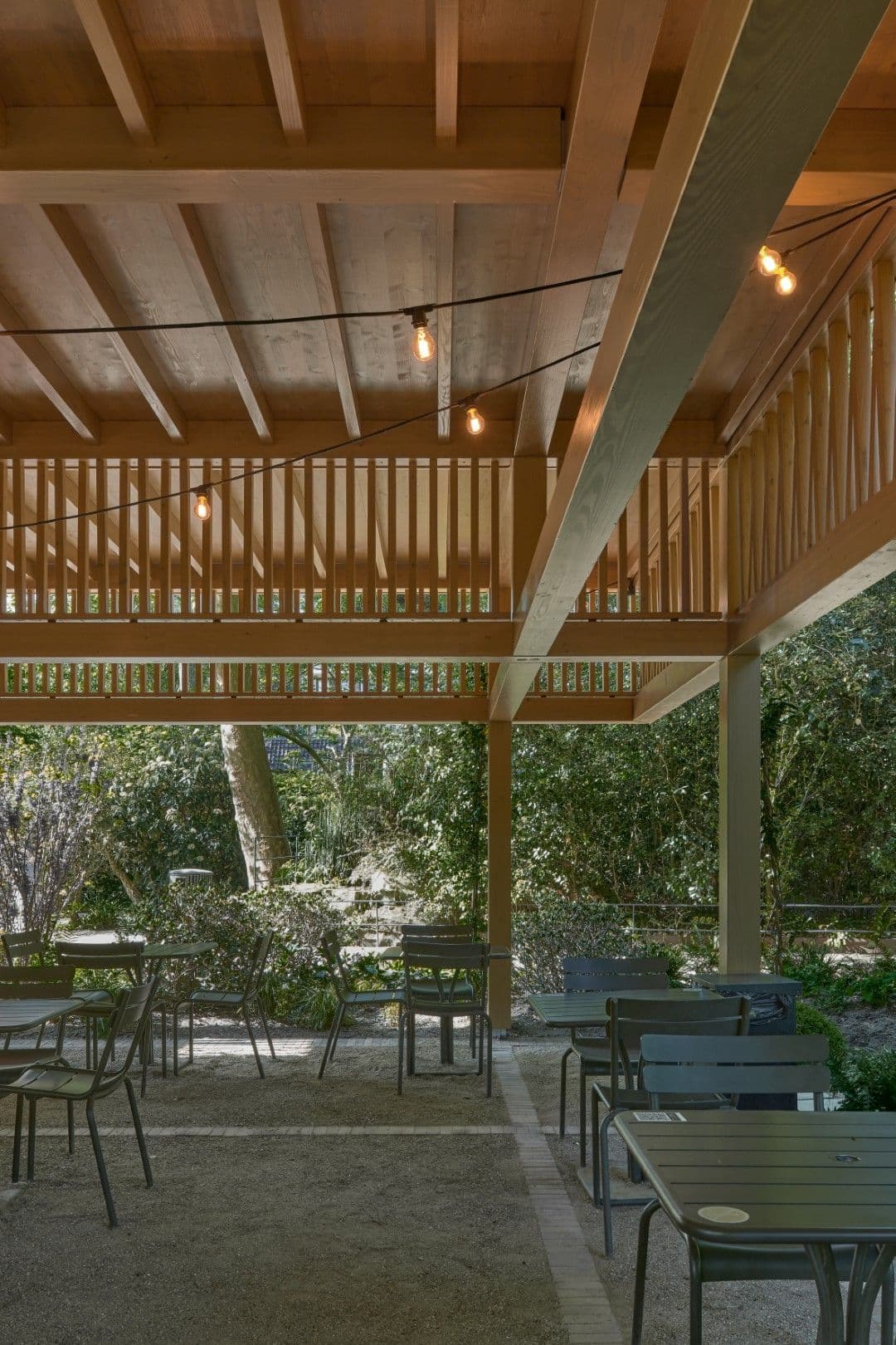 Architectural project - open ceiling, gathering place, rustic outdoor, natural design, garden terrace, shaded area, relaxing vibe, covered terrace, dappled light, natural materials, wood, timber, sustainable design, community space, green, neutral tones, timber structure, exposed beams, beige, brown, eco friendly, natural setting, timber construction, simple design, wood beams, minimalist style, social space, outdoor pavilion, outdoor seating, wood structure, biophilic design, timber roof, nature view, dining area, earthy tones, warm atmosphere, casual dining, cozy corner, open air, outdoor dining, green surroundings, connection with nature, garden space