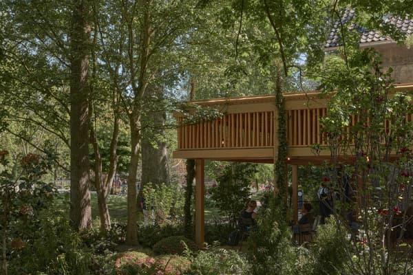 Architectural project - garden pavilion, outdoor lounge, integration with nature, open air space, shaded area, quiet escape, woodland escape, natural materials, wood, timber, timber frame, natural light, outdoor living, eco design, daylight, light wood, natural setting, natural textures, rustic charm, serene atmosphere, relaxation spot, green architecture, biophilic design, rustic style, earthy tones, treehouse, tranquil vibe, environmentally friendly, garden view, nature integration, immersive nature, outdoor shelter, eco architecture, garden seating, wooden structure, lush greenery, outdoor retreat, cozy outdoors, outdoor relaxation