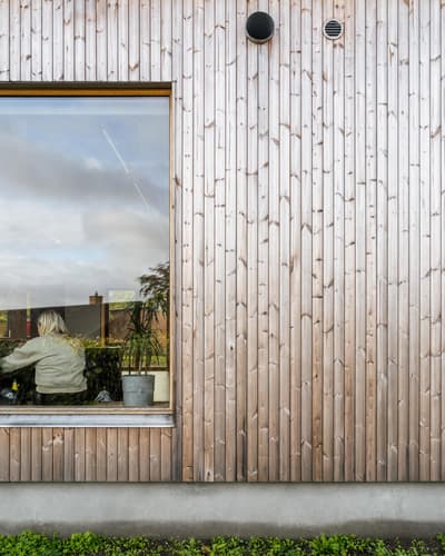 Architectural project - natural materials, architectural detail, wood, timber, natural light, glass, warm tones, eco design, sustainable architecture, grey, neutral tones, daylight, beige, wood facade, minimalist facade, light wood, exterior wall, eco friendly, honey wood, Scandinavian style, green architecture, low carbon, biophilic design, sustainable home, passive house, contemporary home, timber cladding, timber house, large window, outdoor view, energy efficient, nature-inspired, garden view, inviting exterior, sleek design, residential, vertical slats, modern exterior, picture window, exterior cladding