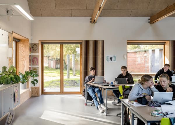 Architectural project - gray, flexible space, cozy environment, gathering spot, timber details, modern classroom, airy ambiance, wood, timber, natural light, passive design, sustainable design, warm tones, natural tones, community space, multifunctional area, neutral tones, daylight, beige, concrete, light wood, contemporary design, Scandinavian style, calming space, relaxed atmosphere, eco-friendly materials, creative space, clean lines, large windows, plaster, open layout, minimalist decor, study area, bright interior, nordic influence, wooden accents, educational space, learning environment, indoor plants, informal seating