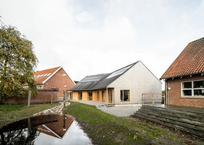 Architectural project - terrace, natural facade, minimal facade, solar panel, garden, solar panels, countryside vibe, modern barn, rustic elements, serene environment, wood, timber, outdoor space, warm tones, sustainable architecture, neutral tones, landscape architecture, light wood, eco friendly, rural architecture, low carbon, biophilic design, open landscape, rural design, timber cladding, wood cladding, wood house, timber house, rural home, countryside home, energy efficient, sloped roof, pitched roof, brick, barn style, nature integration, green design, minimalist exterior, water feature, passive solar, modern rural, sustainable living, rural retreat