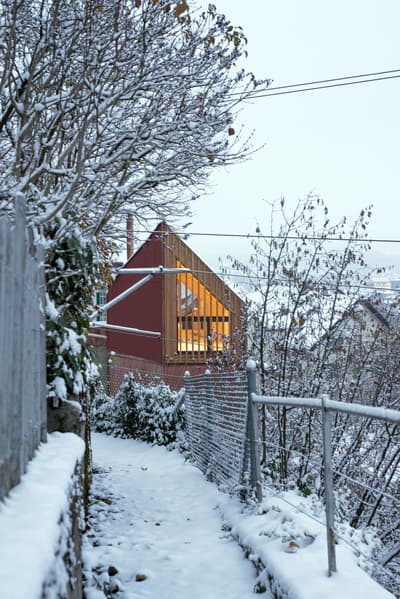 Architectural project - warm glow, rustic setting, modern barn, wood, timber, outdoor living, sustainable design, warm tones, evening light, beige, wood facade, timber facade, light wood, natural setting, farmhouse style, rural architecture, Scandinavian vibe, wood cladding, white, Nordic design, inviting home, outdoor view, cozy cabin, cozy atmosphere, nature retreat, rural setting, barn style, countryside living, minimalist exterior, eco retreat, modern cottage, architectural contrast, red