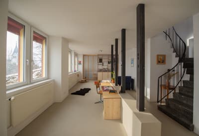Architectural project - flexible layout, beige floor, home workspace, wooden desk, productive environment, airy ambiance, wood, steel, natural light, inviting atmosphere, sustainable design, exposed structure, contemporary style, neutral tones, daylight, beige, concrete, steel columns, multifunctional space, functional design, compact space, neutral palette, minimalist design, black, Scandinavian vibe, light tones, clean lines, white walls, light filled, large windows, white, window view, energy efficient, open plan, eco friendly space, cozy corner, serene setting, home office, work from home, bright interior, residential, minimalist shelving, modern interior, simple furniture, bright room, urban apartment, practical layout