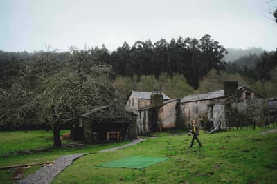 Architectural project - eco living, rural landscape, rustic setting, garden area, country house, old-world charm, historic vibe, heritage style, pastoral setting, farmhouse, weathered stone, natural path, stone path, large garden, pathway, stone house, rural environment, natural materials, outdoor space, outdoor living, natural tones, grey, green, brown, eco friendly, rustic charm, cozy vibe, stone, traditional architecture, quiet retreat, nature retreat, countryside, heritage building, traditional style, rustic home, lush greenery, peaceful atmosphere, green space, natural surroundings, sustainable living