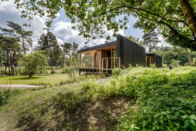 Architectural project - terrace, countryside escape, Scandinavian cabin, deck area, nature cabin, single story, nordic retreat, low carbon home, nature tones, natural materials, wood, timber, outdoor living, eco design, sustainable architecture, green, landscape architecture, timber facade, eco friendly, wood exterior, natural setting, minimalist design, black, biophilic design, passive house, nature view, modular home, rural home, earthy tones, environmental design, forest retreat, forest view, garden view, woodland retreat, eco cabin, green design, wooden retreat, sustainable house, seamless indoor outdoor, sustainable living, modern cabin, black cladding, dark wood