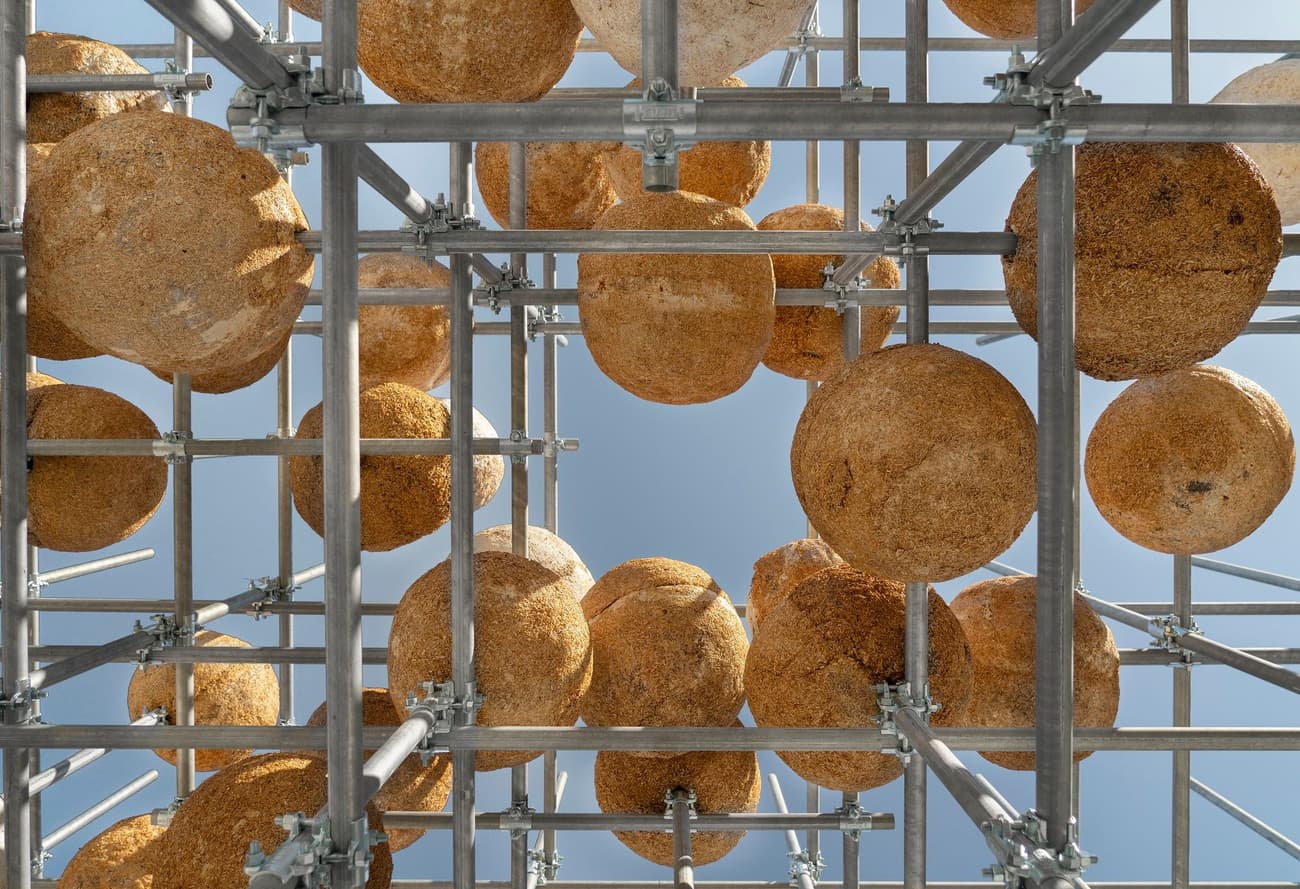 Architectural project - sky, urban art, public art, creative installation, art installation, modern art, natural materials, architectural detail, scaffolding, metal frame, steel, sustainable design, warm tones, modular design, eco design, industrial aesthetic, innovative design, architectural installation, beige, brown, geometric pattern, open structure, outdoor structure, lightweight structure, steel frame, minimalist structure, low carbon, earth tones, natural texture, sky view, visual interest, organic shapes