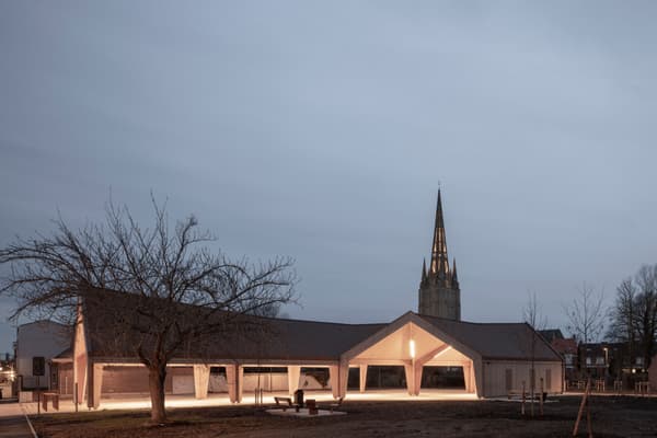 Architectural project - gray, integration with nature, outdoor lighting, evening glow, large openings, civic building, light gray, wood, timber, outdoor space, sustainable design, contemporary architecture, urban landscape, neutral tones, timber structure, multi-use space, beige, brown, concrete, steel columns, eco friendly, minimalist design, eco materials, community hub, gathering area, community center, open facade, wood construction, geometric design, low carbon, modern facade, gable roof, public building, warm lighting