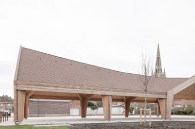 Architectural project - angular roof, welcoming atmosphere, slanted roof, architectural landmark, terracotta roof, public pavilion, natural materials, wood, timber, outdoor space, timber frame, passive design, warm tones, sustainable construction, contemporary architecture, urban landscape, exposed beams, beige, brown, open air design, eco friendly, open structure, wooden beams, natural textures, minimalist design, neutral colors, public space, gathering area, event space, geometric design, modern pavilion, light tones, wood structure, circular design, pitched roof, open pavilion, eco architecture, airy feel, exterior space, clay tiles, tiles, versatile space