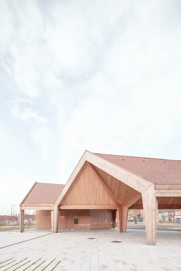 Architectural project - gathering place, timber pavilion, architectural landmark, contextual design, architectural beams, timber canopy, wood design, natural materials, design focus, timber, raw materials, sustainable design, warm tones, natural tones, community space, exposed beams, spacious layout, beige, wood facade, timber facade, roof detail, light wood, eco friendly, open structure, eco structure, timber construction, Scandinavian style, light brown, neutral palette, minimalist design, outdoor pavilion, public space, event space, wood construction, natural finish, CLT, landscape integration, clean lines, white, modern architecture, Nordic style, airy space, pitched roof, natural aesthetics, gable roof, bright space, wooden structure, innovative architecture