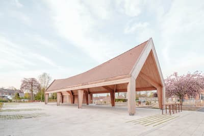 Architectural project - minimal intervention, gathering place, minimal style, timber pavilion, terracotta roof, communal area, structural clarity, suburban setting, natural materials, wood, timber, passive design, eco design, community space, urban landscape, exposed beams, light wood, eco friendly, Scandinavian influence, airy design, outdoor structure, honey wood, wood beams, timber beams, serene atmosphere, contemporary design, neutral palette, minimalist design, outdoor seating, pavilion, sustainable structure, tranquil setting, raw wood, natural finish, modern pavilion, green architecture, low carbon, clean lines, light filled, Nordic design, beige tones, pitched roof, open pavilion, warm vibe, gabled roof, soft tones, green space, welcoming space, clay tiles