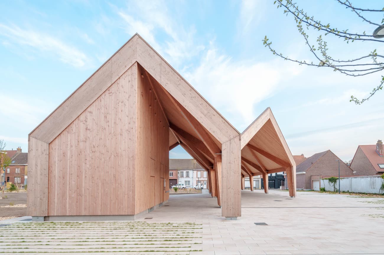 Architectural project - architectural landmark, spacious design, natural materials, wood, timber, eco-conscious, sustainable design, sustainable construction, neutral tones, daylight, gathering space, beige, light wood, open air design, eco friendly, Scandinavian influence, urban oasis, sunlight, honey wood, contemporary design, minimalist style, social space, community hub, public space, community center, outdoor venue, clean aesthetic, timber building, modern pavilion, structural wood, exposed wood, landscape integration, modern minimalism, light filled, timber cladding, bright exterior, Nordic design, open layout, environmental design, nature connection, gable roof, raw finish, eco architecture, wooden structure, airy atmosphere, welcoming space, inviting environment, natural beauty, geometric form, architectural lines