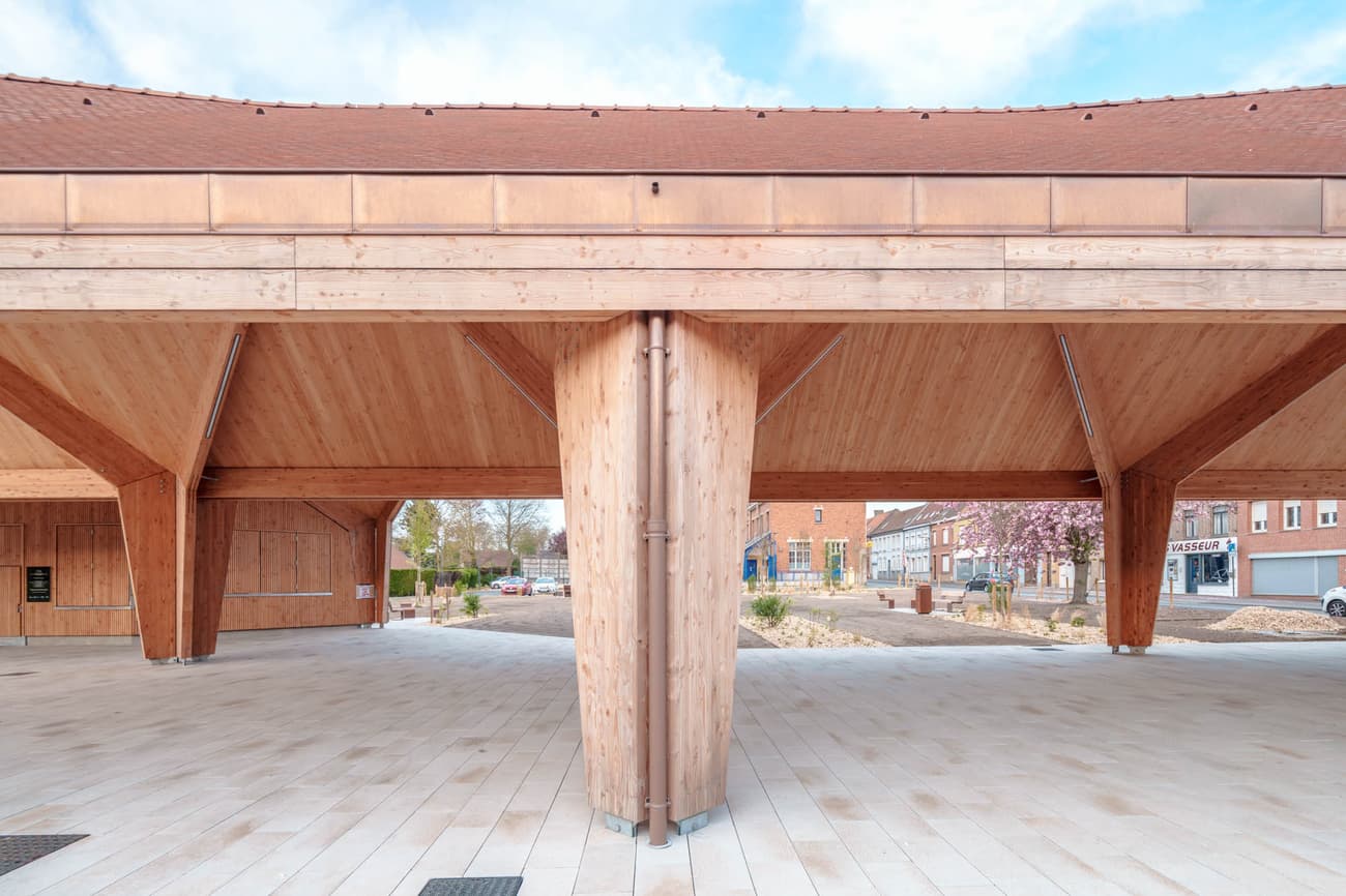 Architectural project - public venue, timber columns, timber pavilion, natural materials, architectural detail, wood, timber, urban setting, outdoor space, timber frame, natural light, sustainable design, warm tones, community space, contemporary architecture, exposed beams, gathering space, light wood, open structure, honey wood, timber beams, rustic modern, natural textures, Scandinavian style, neutral palette, minimalist design, public space, social hub, wood construction, modern pavilion, structural wood, biophilic design, Nordic style, beige tones, inviting space, outdoor shelter, open air, eco architecture, airy atmosphere, wooden columns, light beige