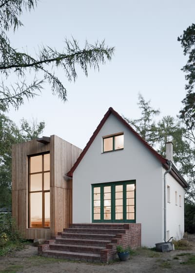 Architectural project - rustic elegance, open views, modern farmhouse, modern extension, contemporary addition, house extension, seamless blend, brick steps, symmetrical design, eco-friendly house, volumetric design, simple geometry, outdoor steps, harmonious integration, functional addition, natural materials, wood, timber, sustainable design, glass, neutral tones, beige, brown, wood facade, timber facade, rustic charm, exterior, low carbon, biophilic design, passive house, clean lines, large windows, timber cladding, wood cladding, white, rural home, energy efficient, pitched roof, brick, garden view, gable roof, glass windows, cozy exterior, countryside house, family home, cozy home, modern rural, minimal landscaping, architectural contrast, warm materials, inviting facade