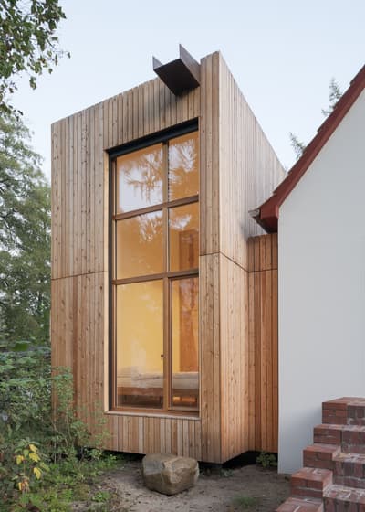 Architectural project - soft glow, modern extension, countryside vibe, contemporary addition, residential extension, warm facade, vertical texture, natural materials, architectural detail, wood, timber, passive design, glass, warm tones, sustainable architecture, grey, green, neutral tones, brown, timber facade, exterior design, minimalist facade, daylight optimization, eco friendly, wood exterior, rustic charm, Scandinavian style, minimalist design, natural ventilation, clean lines, timber cladding, simple elegance, white, inviting home, large window, energy efficient, brick, cozy atmosphere, outdoor connection, garden view, nature integration, nordic influence, floor-to-ceiling window, vertical slats