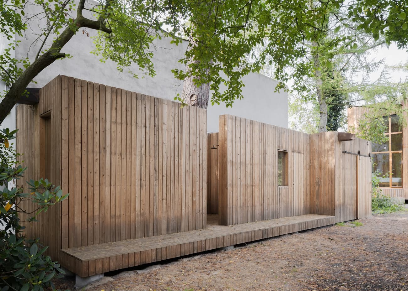 Architectural project - linear design, natural retreat, compact structure, outdoor walkway, retreat, calm environment, woodland architecture, timber walkway, secluded cabin, woodland escape, understated style, serene vibe, natural materials, eco-friendly design, wood, timber, outdoor space, passive design, warm tones, green building, wood facade, timber facade, light wood, honey wood, natural textures, peaceful setting, minimalist design, relaxed atmosphere, sustainable building, timber architecture, low carbon, biophilic design, clean lines, timber cladding, energy efficient, rustic cabin, earthy tones, nature-inspired, forest setting, natural environment, eco cabin, nature integration, vertical cladding, simple lines, wooden exterior, modern cabin, small footprint