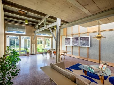 Architectural project - cozy living, modern decor, sustainable, blue accents, modern loft, loft apartment, airy room, relaxing area, terrazzo floor, light blue, wood, timber, steel, natural light, recycled materials, warm tones, grey, neutral tones, steel beams, exposed beams, beige, light wood, natural wood, industrial elements, eco friendly, Scandinavian style, minimalist design, casual seating, multifunctional, adaptable space, eco home, large windows, indoor outdoor, white, Nordic design, inviting home, timber ceiling, open layout, open plan, living area, greenery, garden view, bright interior, cozy vibes, wood ceiling, indoor plants, living space, picture windows
