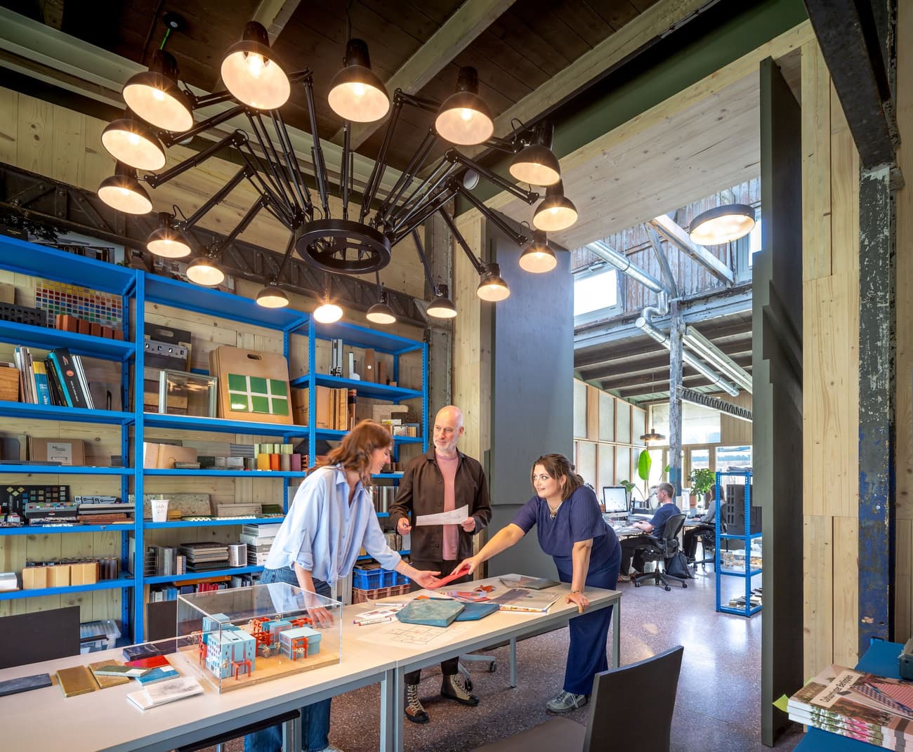 Architectural project - industrial office, collaborative space, modern workspace, creative studio, polished concrete, large table, modern office, professional environment, stylish office, wood, industrial design, steel, natural light, rustic touch, inviting atmosphere, sustainable design, reclaimed materials, recycled materials, industrial aesthetic, innovative design, grey, neutral tones, exposed beams, functional space, daylight, industrial vibe, architectural elements, industrial style, blue, contemporary design, steel structure, eco-friendly materials, exposed wood, timber accents, warm ambiance, open shelves, sleek design, concrete floor, modern interior