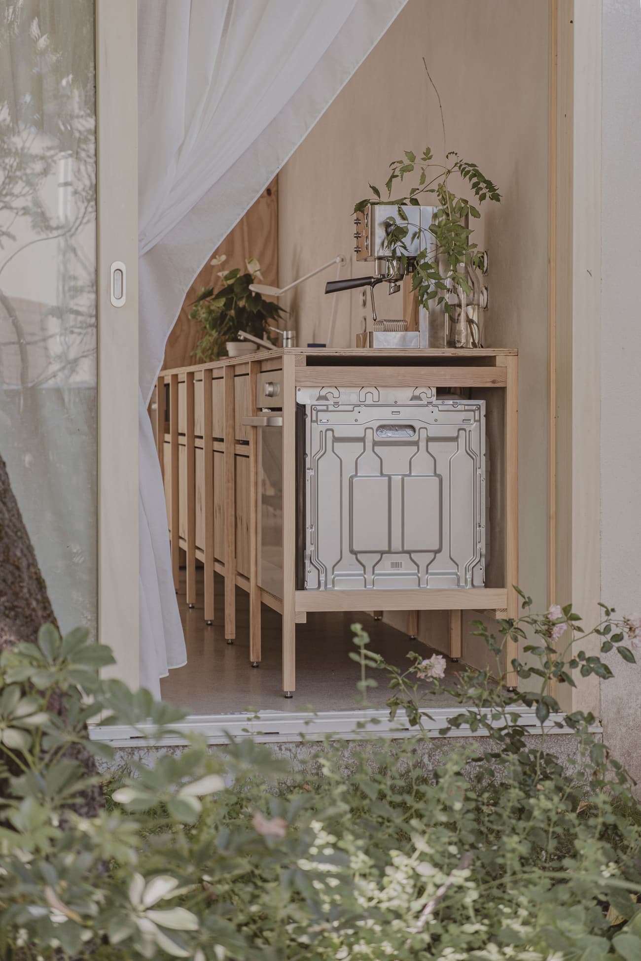 Architectural project - indoor greenery, airy interior, indoor garden, plant decor, modern garden, soft lighting, pastel tones, wood, timber, relaxed vibe, natural light, sustainable design, glass, neutral tones, daylight, beige, light wood, urban oasis, natural textures, Scandinavian style, neutral palette, cozy space, modern rustic, white, eco friendly home, warm ambiance, home kitchen, earthy tones, nature-inspired, minimalist kitchen, wood cabinetry, timber cabinetry, compact kitchen, glass door, nordic influence, seamless transition, small kitchen, sliding door, open shelving