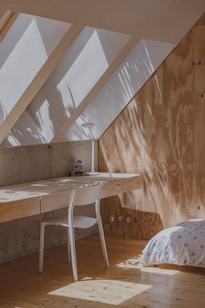Architectural project - exposed concrete, wood wall, skylights, cozy workspace, natural lighting, minimal style, timber desk, calm vibe, wood desk, attic office, sustainable materials, timber, natural light, warm tones, eco design, neutral tones, daylight, plywood, beige, concrete, light wood, natural wood, multifunctional space, compact space, honey wood, rustic modern, minimalist design, plywood wall, modern rustic, passive house, white, Nordic style, warm atmosphere, cozy atmosphere, residential design, peaceful vibe, Scandinavian design, home office, timber wall, concrete wall, sloped ceiling, creative corner