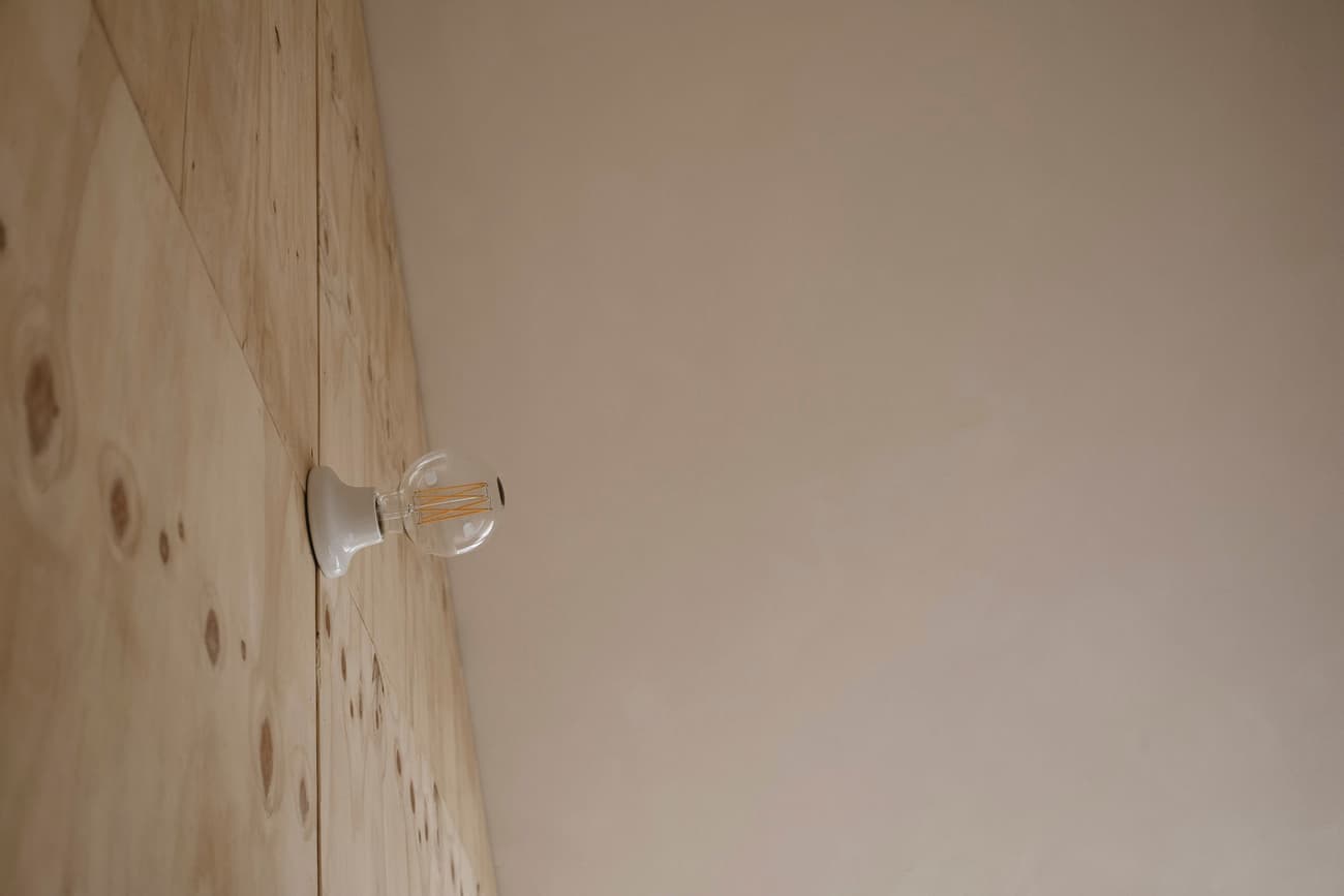 Architectural project - subtle elegance, wooden wall, modern lighting, minimalist lighting, wall sconce, minimal design, cozy interior, warm interior, calming atmosphere, natural materials, wood, timber, raw materials, sustainable design, warm tones, eco design, plywood, beige, light wood, simple design, serene atmosphere, contemporary design, Scandinavian style, light brown, neutral palette, plywood wall, earthy texture, clean lines, wood cladding, Nordic design, plaster, timber interior, inviting space, warm colors, natural texture, simple forms, warm vibe, beige wall, modern interior, smooth finish