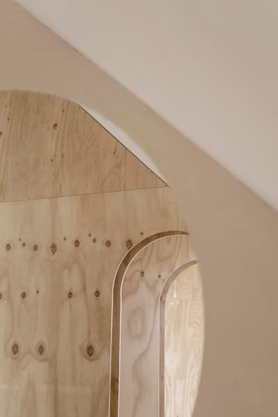 Architectural project - subtle elegance, eco interior, arched doorway, organic feel, smooth surface, refined design, simple interior, warm interior, natural materials, architectural detail, sustainable design, warm tones, light wood, natural wood, eco friendly, contemporary touch, rustic modern, Scandinavian style, neutral palette, minimalist design, timber detailing, raw wood, natural finish, plywood wall, structural detail, modern rustic, timber cladding, cozy vibe, inviting space, wood grain, wooden elements, wooden texture, nordic influence, timber wall
