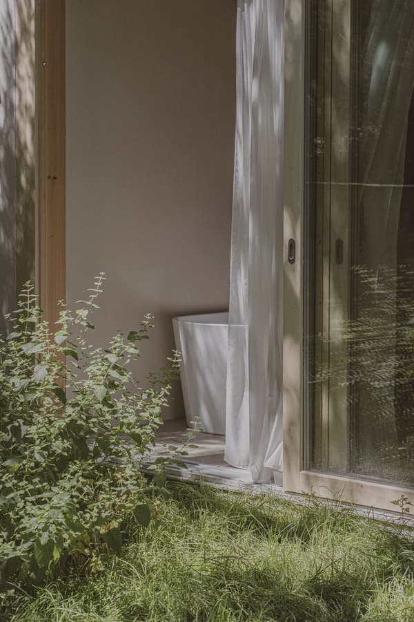 Architectural project - simple aesthetic, Scandinavian touch, plant life, curtain, bright ambiance, peaceful space, garden room, comfort zone, relaxation space, natural materials, wood, natural light, glass, warm tones, eco design, green, neutral tones, daylight, beige, eco friendly, private retreat, serene atmosphere, minimalist design, glass doors, soft textures, low carbon, biophilic design, passive house, modern minimalism, indoor outdoor, white, wood frame, environmental design, nature connection, cozy corner, greenery, garden view, sliding doors, fresh air, airy feel, soft light, clean design, sustainable living, calm setting