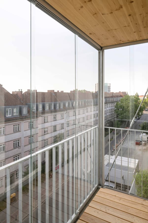 Architectural project - metal railing, minimalist living, bright light, glass enclosure, balcony view, steel railing, relaxation space, natural materials, wood, timber, steel, outdoor space, eco-conscious, sustainable design, glass, warm tones, modular design, daylight, exterior design, light wood, compact space, sleek lines, Scandinavian style, neutral palette, minimalist design, biophilic design, modern architecture, Nordic style, beige tones, timber ceiling, glass walls, sleek design, floor to ceiling glass, modern style, wood ceiling, open space, urban context, urban living, cityscape view, urban view
