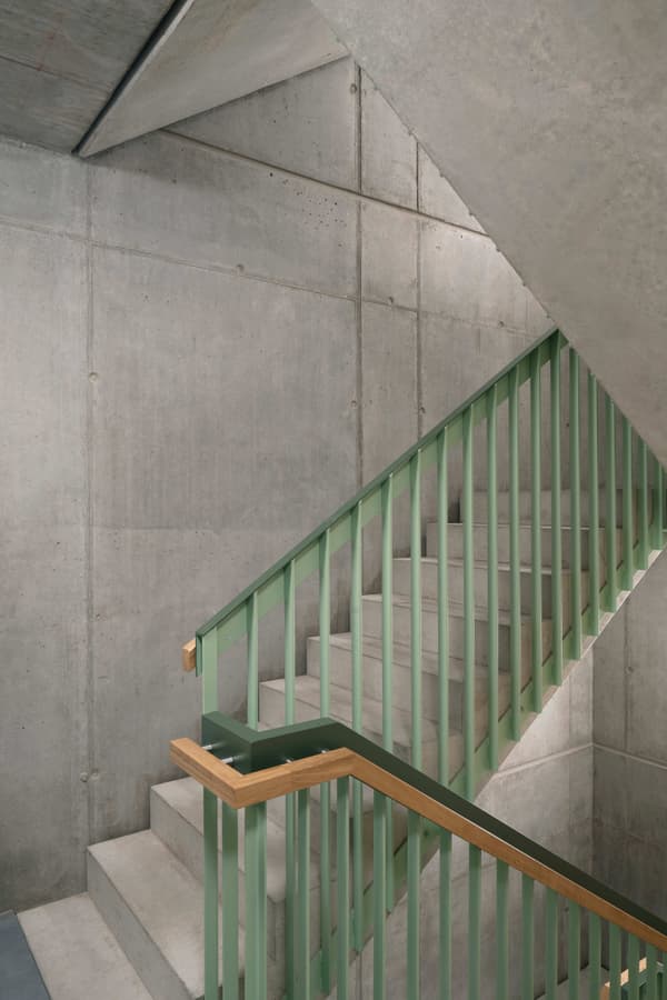 Architectural project - metal railing, concrete finish, exposed concrete, modern industrial, loft style, raw aesthetic, unfinished look, urban chic, polished concrete, concrete walls, textured concrete, concrete stair, green accent, contemporary look, architectural detail, eco-friendly design, wood, raw materials, grey tones, metal, grey, green, urban environment, industrial vibe, concrete, structural design, light wood, industrial elements, architectural texture, minimalist vibe, minimalist architecture, neutral palette, minimalist design, urban space, industrial chic, durable materials, modern architecture, sleek design, simple lines, urban style, green railing, urban interior