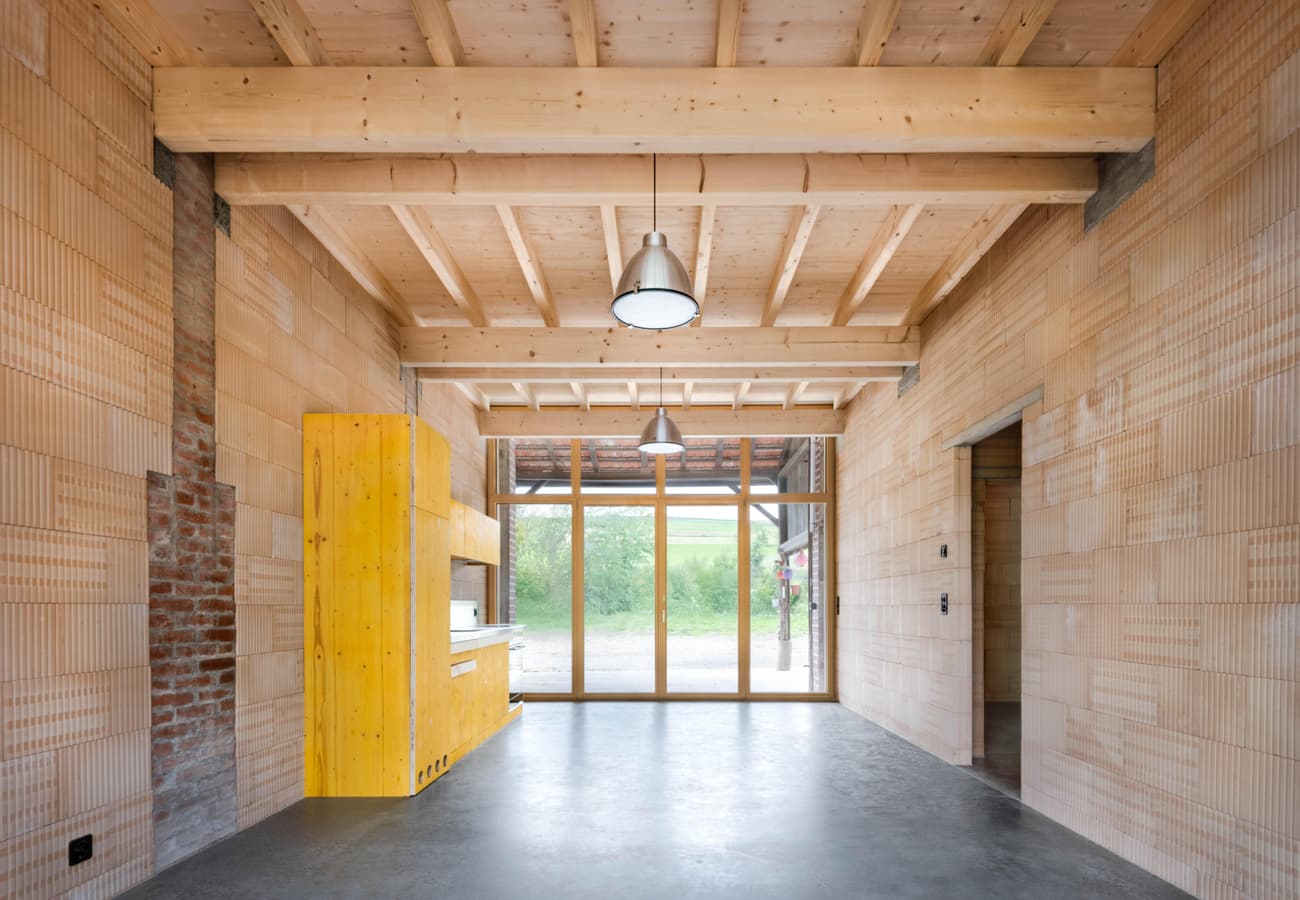Architectural project - modern renovation, brick wall, exposed brick, kitchen area, Scandinavian cabin, pendant lights, nordic retreat, minimal design, natural materials, wood, timber, raw materials, natural light, sustainable design, glass, eco design, neutral tones, exposed beams, daylight, wooden ceiling, beige, concrete, light wood, multifunctional space, simple design, rustic modern, natural textures, light brown, neutral palette, warm wood, modern rustic, contemporary home, indoor outdoor, eco friendly home, cozy vibe, large window, timber ceiling, timber interior, open layout, open plan, dining area, inviting space, brick, warm vibe, grey floor, glass door, earthy textures, concrete floor, wood interior