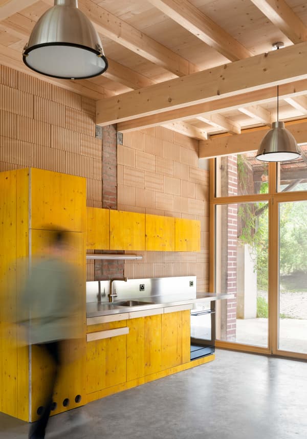 Architectural project - silver, workshop vibe, industrial kitchen, brick wall, modern loft, pendant lighting, urban industrial, modern appliances, custom cabinetry, vibrant kitchen, new build, cozy interior, warm interior, wood, timber, raw materials, city living, natural light, sustainable design, yellow, warm tones, contemporary style, grey, neutral tones, exposed beams, daylight, industrial vibe, concrete, multifunctional space, eco friendly, compact space, simple design, minimalist style, urban design, industrial chic, indoor outdoor, timber ceiling, home kitchen, open layout, open plan, terracotta wall, terracotta, bright interior, modern kitchen, wood ceiling, concrete floor, renovation, urban home