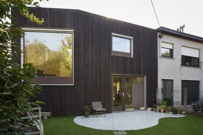 Architectural project - natural materials, architectural design, sustainable materials, wood, timber, grey, glass, eco design, green, contemporary structure, wood facade, timber facade, eco friendly, minimalist design, black, glass doors, passive house, large windows, indoor outdoor, white, home facade, cozy vibe, energy efficient, earthy tones, garden view, residential building, warm exterior, sleek design, family house, modern exterior, green space, wood paneling, glazing, modern house, dark tones, black cladding, dark facade, backyard seating, lawn area, urban home, dwelling, contrast facade, mixed materials, texture contrast, inviting front, garden space, natural look, black wood, outdoor relaxation, stylish exterior