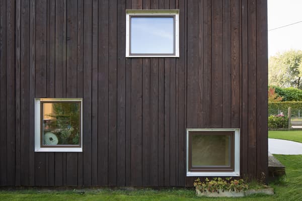 Architectural project - natural materials, architectural detail, wood, timber, natural light, glass, warm tones, daylight, wood facade, timber facade, natural wood, exterior wall, simple design, modern simplicity, Scandinavian style, minimalist design, sustainable building, warm wood, passive house, contemporary home, eco friendly home, Nordic style, energy efficient, earthy tones, nature-inspired, greenery, garden view, residential architecture, cozy exterior, private residence, wooden cladding, outdoor design, textured facade, earthy textures, vertical cladding, modern exterior, dark tones, dark wood, residential facade, square windows, framed windows, eco facade, compact window, refined architecture, geometry in design, outdoor greenery, plant box, inviting facade