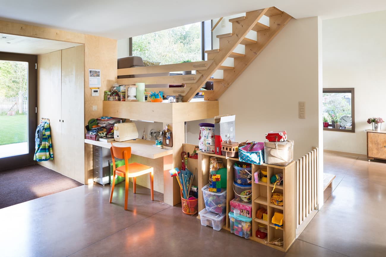 Architectural project - sustainable materials, playful design, natural light, inviting atmosphere, eco-conscious, pastel colors, warm tones, neutral tones, daylight, plywood, light wood, functional design, Scandinavian influence, simple design, multifunctional, vibrant space, creative space, light filled, cozy vibe, casual living, open layout, minimalist decor, child friendly, cozy corner, wooden elements, family living, interior, modern living, residential, built-in storage, home renovation, small home, play area, kids corner, compact home, home stairs, plywood stairs, storage under stairs, colorful space, bright home, welcoming home, Nordics style, family-friendly, vibrant orange, modern retrofit