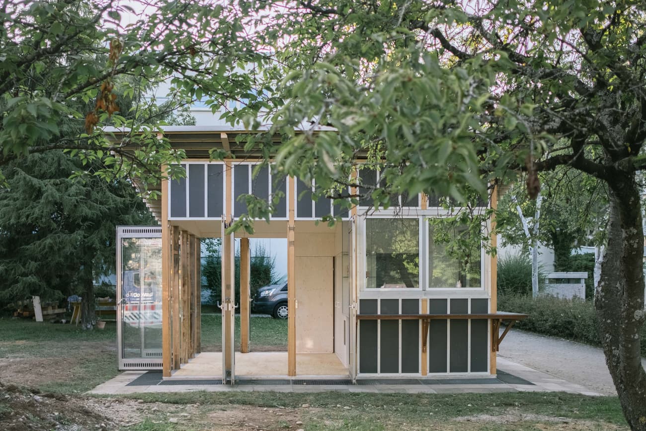 Architectural project - tiny house, off-grid, small house, prefab home, minimalist shelter, prefabricated, garden house, nature integrated, retreat house, wood, timber, grey tones, wooden frame, outdoor living, passive design, glass, natural tones, modular design, green building, sustainable architecture, eco friendly, natural setting, eco materials, wood panels, biophilic design, indoor outdoor, energy efficient, beige tones, open plan, glass walls, nature-inspired, simple living, vacation home, sliding doors, urban escape, glass facade, sustainable living, modern cabin, compact home