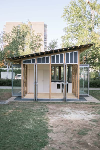 Architectural project - tiny house, flexible space, minimal living, wooden siding, wood, timber, temporary structure, metal, timber frame, natural light, sustainable design, glass, warm tones, modular design, green building, transparent walls, grey, neutral tones, daylight, beige, light wood, eco friendly, natural setting, retreat space, open facade, wood structure, biophilic design, passive house, indoor outdoor, timber cladding, outdoor view, open plan, nature connection, garden retreat, minimalist space, compact living, glass facade, small home