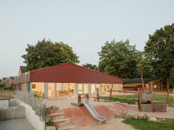 Architectural project - gathering place, welcoming atmosphere, bright facade, wood, timber, metal, natural light, glass, warm tones, eco design, outdoor area, contemporary architecture, grey, green, neutral tones, daylight, beige, concrete, exterior design, natural wood, modern design, natural setting, social space, community center, vibrant space, interactive design, sustainable building, green architecture, low carbon, timber cladding, wood cladding, energy efficient, open plan, pitched roof, child friendly, natural environment, gable roof, educational space, public building, green space, outdoor play, playground, play area, family-friendly, children's area, red, communal space