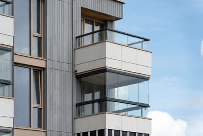 Architectural project - window detailing, multi-story building, metal siding, sleek look, city view, glass railing, building exterior, grey tones, metal, outdoor space, natural light, outdoor living, glass, contemporary style, grey, neutral tones, daylight, beige, minimalist facade, neutral palette, clean lines, architectural details, modern architecture, beige tones, residential building, balcony design, sleek design, facade design, light facade, vertical panels, modern urban, urban retreat, urban facade, city dwelling, urban living
