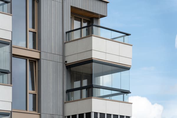 Architectural project - window detailing, multi-story building, metal siding, sleek look, city view, glass railing, building exterior, grey tones, metal, outdoor space, natural light, outdoor living, glass, contemporary style, grey, neutral tones, daylight, beige, minimalist facade, neutral palette, clean lines, architectural details, modern architecture, beige tones, residential building, balcony design, sleek design, facade design, light facade, vertical panels, modern urban, urban retreat, urban facade, city dwelling, urban living