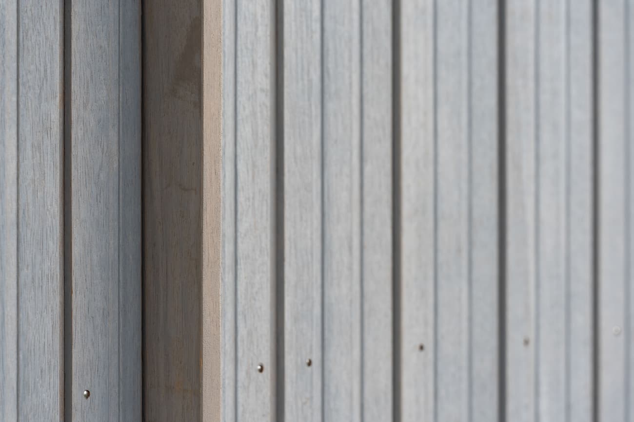 Architectural project - linear design, simple aesthetic, exterior architecture, exterior finish, facade cladding, outdoor cladding, streamlined look, architectural detail, grey tones, eco design, neutral tones, timber facade, geometric pattern, light wood, weathered wood, contemporary design, Scandinavian style, minimalist design, natural finish, timber panels, natural material, textured surface, modern facade, clean lines, wood cladding, harmonious design, modern architecture, sustainable material, wooden texture, sleek design, wood siding, nordic influence, pale wood, vertical panels, timber finish
