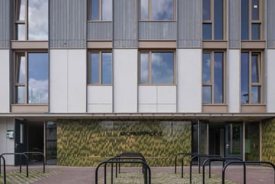 Architectural project - green accents, public venue, grey facade, light grey, green construction, civic building, office building, building exterior, sustainable materials, steel, passive design, glass, community space, sustainable architecture, green, neutral tones, ventilation, urban development, concrete, minimalist design, public space, urban design, low carbon construction, modern architecture, earthy tones, green design, glass windows, contemporary facade, vertical cladding, facade design, insulation, energy efficiency, reflective glass, eco facade, urban vibe