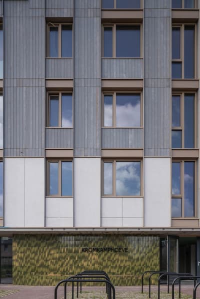 Architectural project - apartment facade, linear design, urban dwelling, metal cladding, grey facade, urban renewal, green facade, sleek look, muted colors, exterior architecture, housing complex, pastel tones, city living, cityscape, passive design, recycled materials, glass, modular design, eco design, sustainable architecture, grey, green, neutral tones, modern construction, geometric design, textured surface, energy efficient, eco-friendly building, residential building, textured facade, contemporary facade, urban architecture, vertical panels, mixed materials, eco facade, urban housing